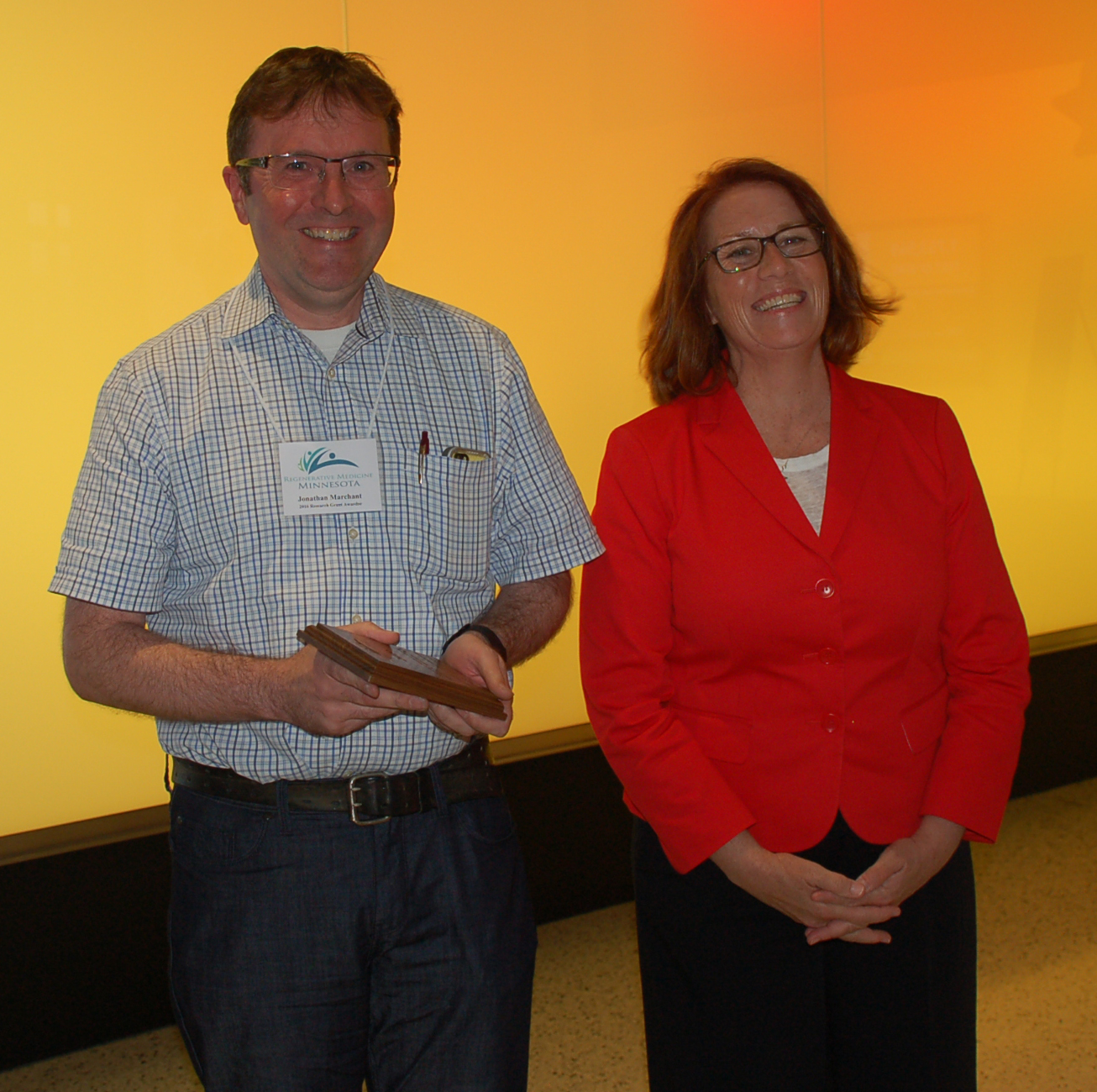 Dr. Jonathan Marchant, seen here with Rep. Erin Murphy, received a Discovery Science Research grant to study a therapy to reverse cell damage caused by Parkinson’s disease.