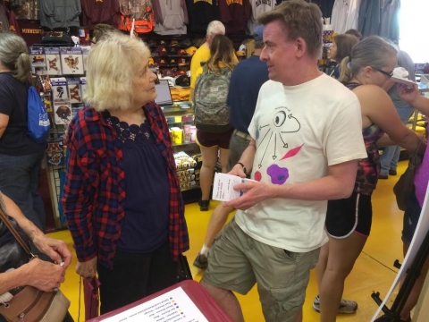 James Dutton, a developmental biologist, discussing regenerative medicine with a State Fair attendee